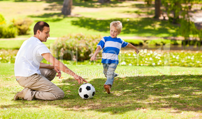 Father playing football with his son