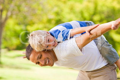 Son playing with his father in the park