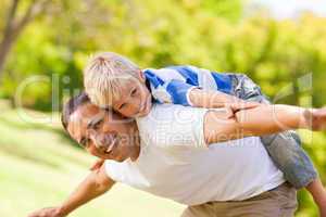 Son playing with his father in the park