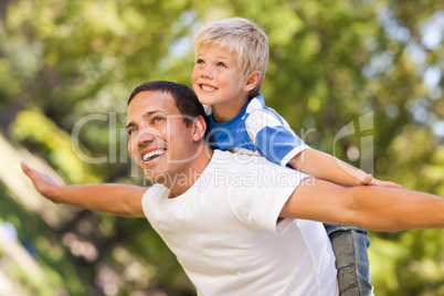 Son playing with his father in the park