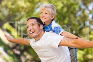 Son playing with his father in the park