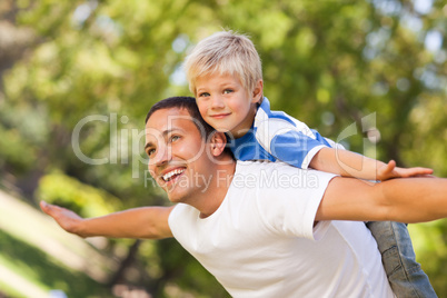 Son playing with his father in the park