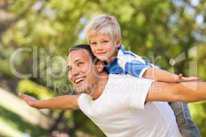 Son playing with his father in the park