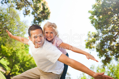 Father playing with his daughter in the park