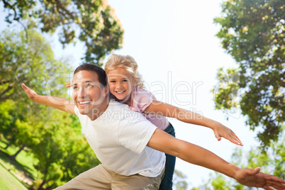 Father playing with his daughter in the park