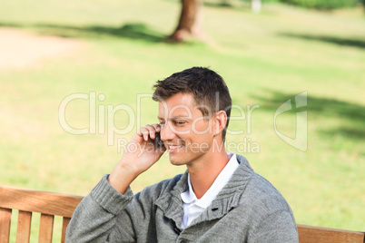 Man phoning on the bench