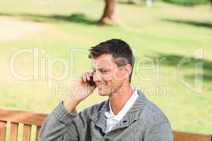 Man phoning on the bench