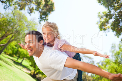 Father playing with his daughter in the park Father playing with his daughter in the park
