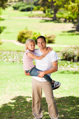 Father with her daughter in the park