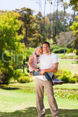 Father with her daughter in the park