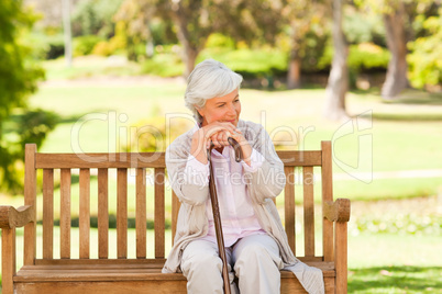 Woman with her walking stick in the park