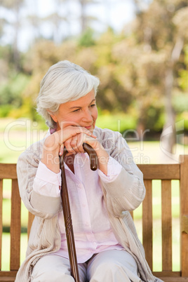 Woman with her walking stick in the park