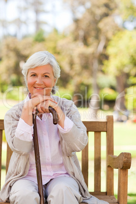 Woman with her walking stick in the park