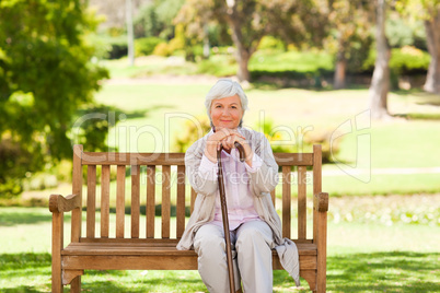 Woman with her walking stick in the park