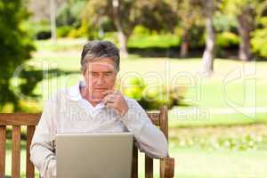 Senior man working on his laptop