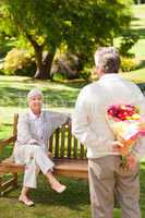 Retired man offering flowers to his wife