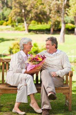 Senior man offering flowers to his wife