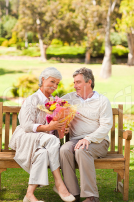 Senior man offering flowers to his wife