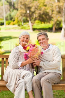 Senior man offering flowers to his wife