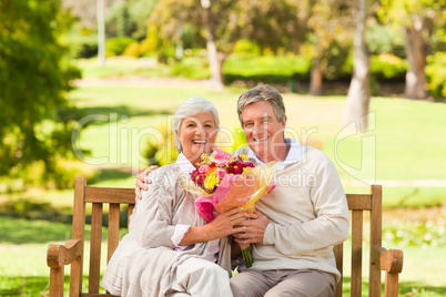 Senior man offering flowers to his wife