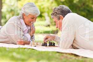 Elderly couple playing chess