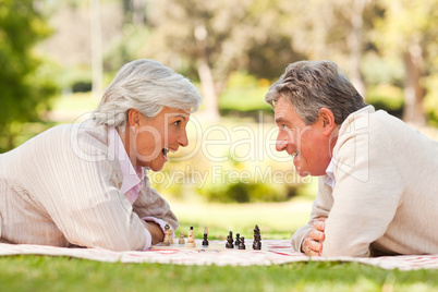 Retired couple playing chess