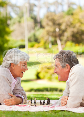 Retired couple playing chess