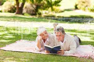 Couple reading a book in the park