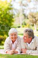 Mature couple lying down in the park