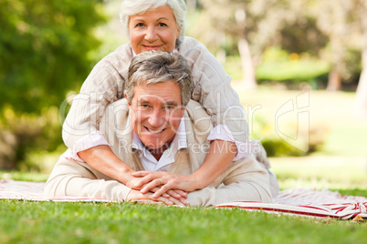 Mature couple lying down in the park