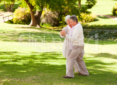 Mature couple dancing in the park