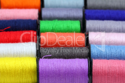 lot of colored thread spools