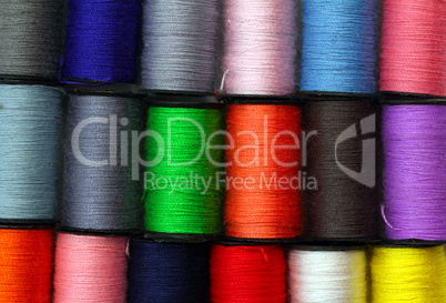 lot of colored thread spools