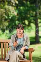 Woman phoning on the bench