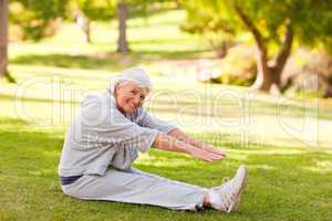 Retired woman doing her stretches in the park