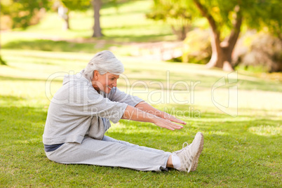 Retired woman doing her stretches in the park