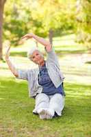 Senior woman doing her stretches in the park