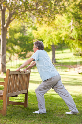 Retired man doing his stretches in the park
