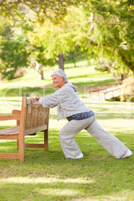 Senior woman doing her stretches in the park