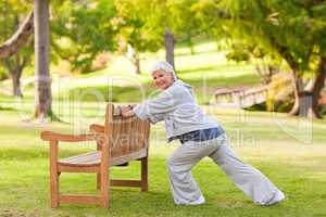 Senior woman doing her stretches in the park