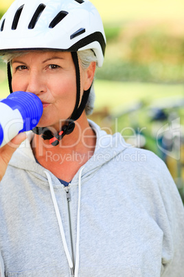 Woman drinking water in the park