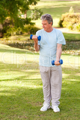 Elderly man doing his exercises in the park