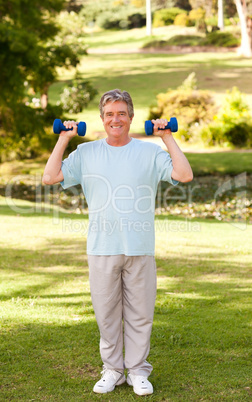 Elderly man doing his exercises in the park