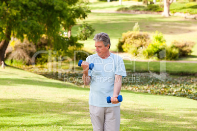 Elderly man doing his exercises in the park