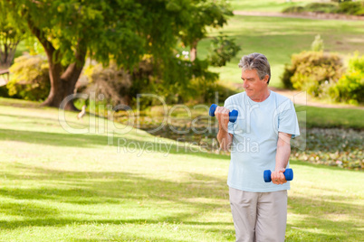 Elderly man doing his exercises in the park