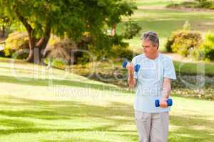 Elderly man doing his exercises in the park