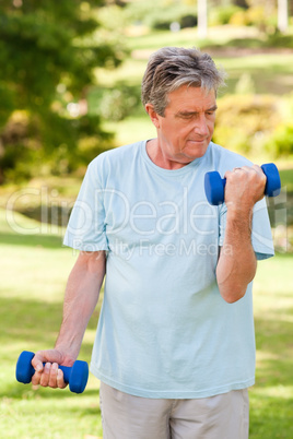 Elderly man doing his exercises in the park