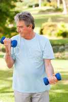 Elderly man doing his exercises in the park