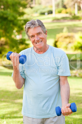 Mature man doing his exercises in the park