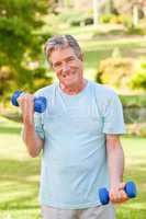 Mature man doing his exercises in the park